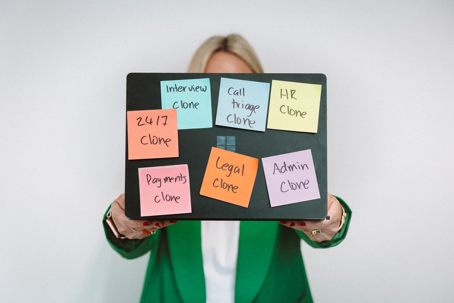 A WorkClone team member holding a board of clone types on sticky notes
